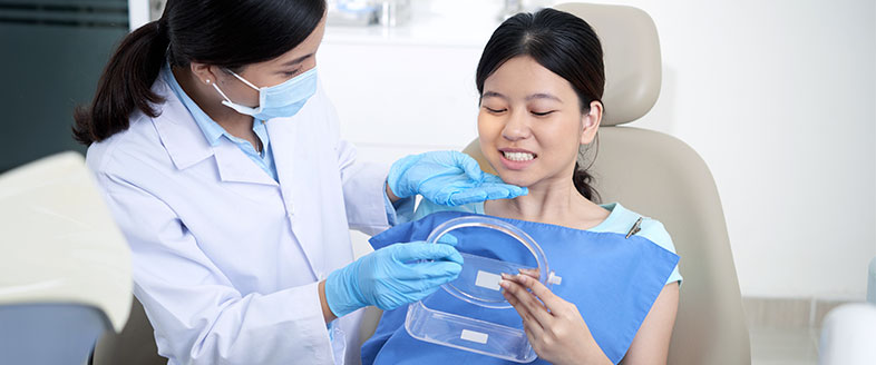  A dentist checking the teeth of her patient